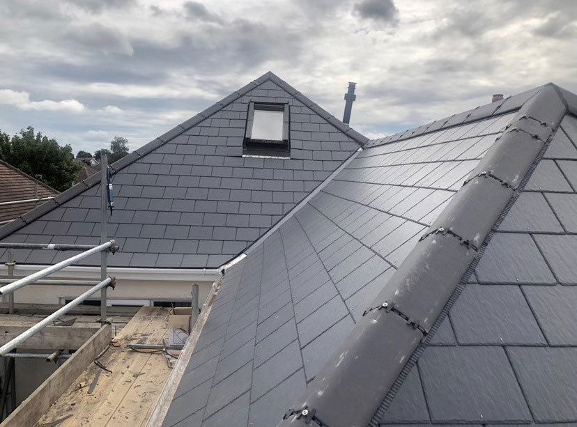Workers from Southampton Roofing performing repairs on a house exterior as part of roof repairs in Eastleigh, with ongoing construction.